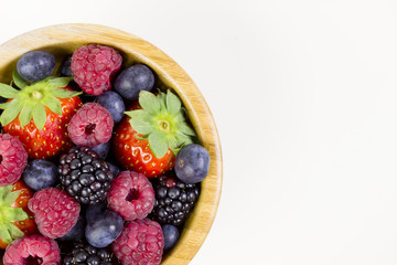 Forest fruits in a wooden bowl