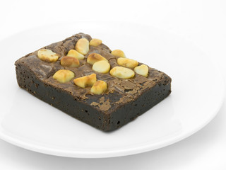Chocolate brownie on a white plate in white background.