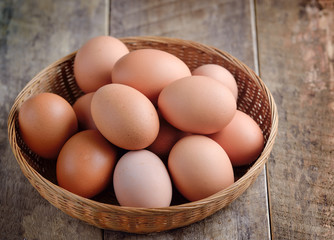 Easter egg in a basket on wodden table