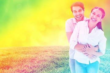 Composite image of cute couple hugging and smiling at camera