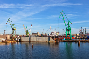 Fototapeta na wymiar A view of a large ship under repair in dry dock at a shipyard