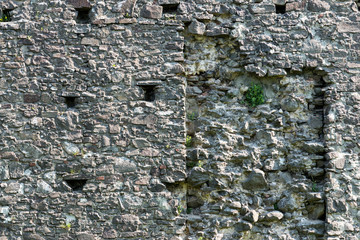 Old stone castle wall texture with cannon windows