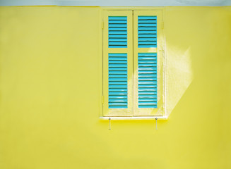 beautiful window on yellow wall