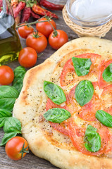 Rustic italian pizza with mozzarella, cheese and basil leaves