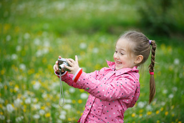 Little girl photographing with her camera