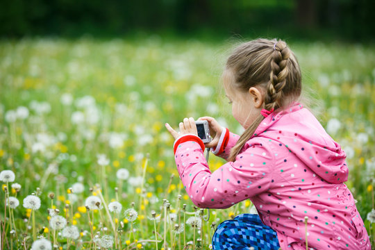 Little girl photographing with her camera