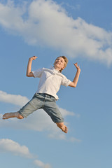 Fototapeta na wymiar Boy on blue sky background