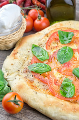Rustic italian pizza with mozzarella, cheese and basil leaves