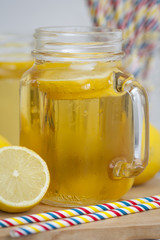 Lemon tea  in a mason jar with straws.
