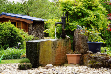 Wassertrog mit Schwengelpumpe im Garten