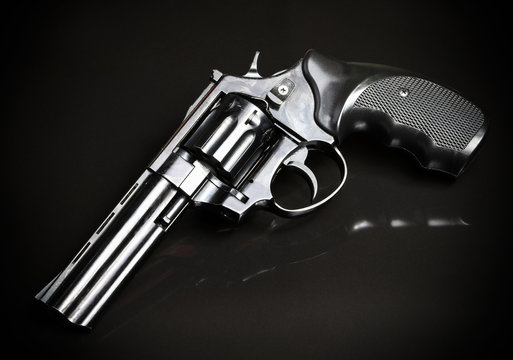 Revolver gun on black background