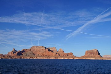 Plane traces in the sky over lake Powell, USA