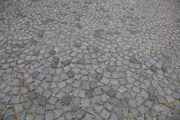 Pavement built by small grey stones. Ideal to use as background.