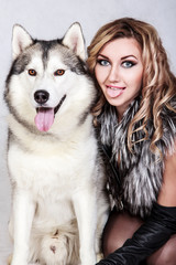 Beautiful young woman with a husky dog