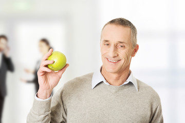 Mature man with an apple.