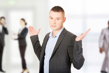 Businessman making undecided gesture.