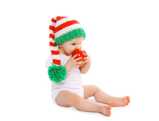 Christmas and childhood concept - baby in bright knitted gnome h