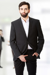 Businessman holding his crotch.
