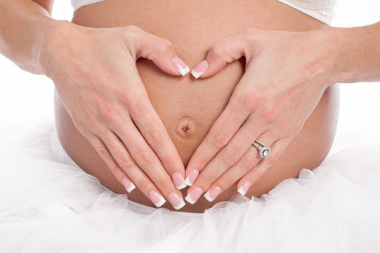 Heart Shaped Hands on a Pregnant Belly