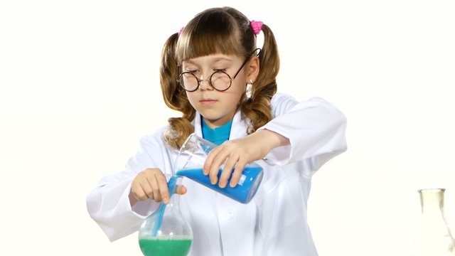 Serious, little girl with ponytails in uniform and round glasses