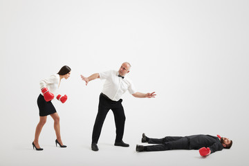 referee holding angry businesswoman