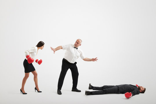 referee holding angry businesswoman - Powered by Adobe