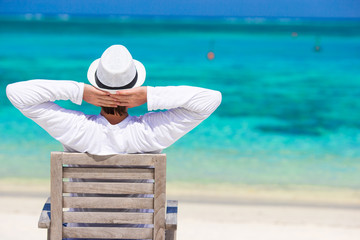 Young man enjoying summer vacation on tropical beach