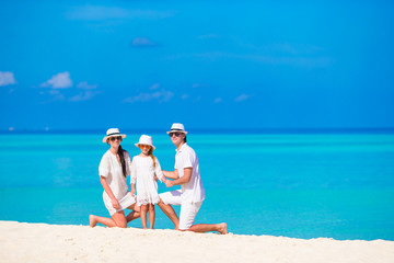 Young family on white beach during summer vacation