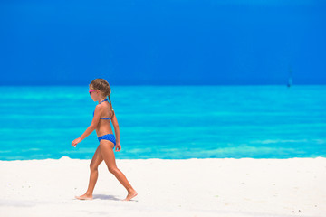 Adorable little girl at beach during summer vacation