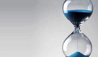Foto op Canvas Time passing. Blue hourglass. © Zerophoto