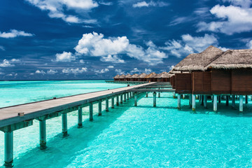 Overwater villas on the tropical lagoon with jetty