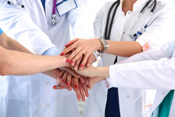 Doctors and nurses in a medical team stacking hands 