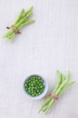 Fresh green vegetables variety on rustic white background from t