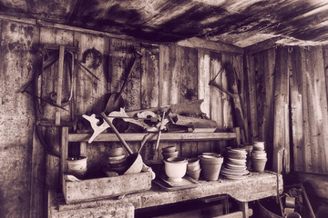 old barn 17th century with tools, pots and pans, vintage effect.
