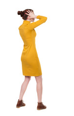 Back view of shocked woman in dress .