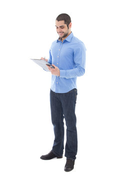 Young Handsome Arabic Man Writing Something On Clipboard Isolate