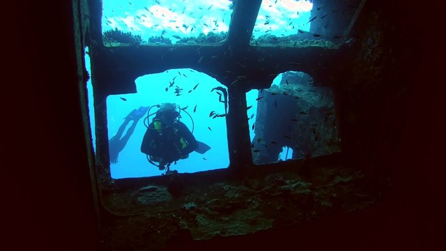Diver looks inside the wreck Giannis D, Red Sea, 

