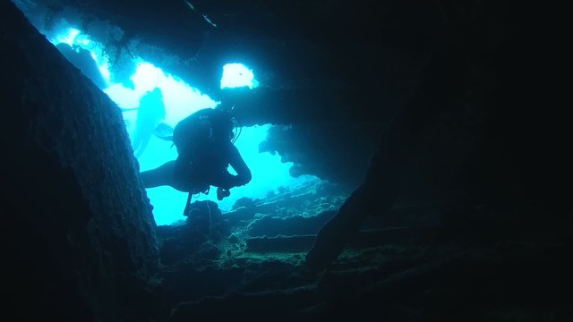 diver swims inside the wreck Dunraven, Red Sea 
