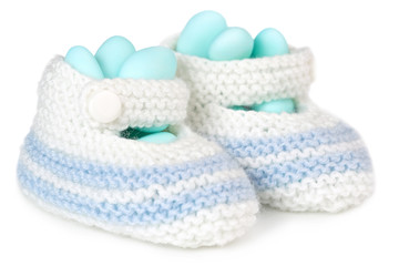 crochet baby booties filled with blue sugared almonds
