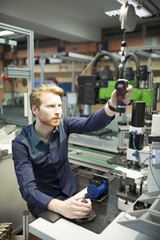 Young man in electronics workshop