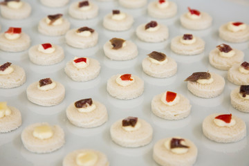 Tartine rotonde farcite ordinate su piano bianco