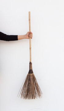 A Woman Holding A Broom