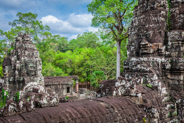 Fototapeta na wymiar Ancient stone faces of Bayon temple, Angkor, Cambodia