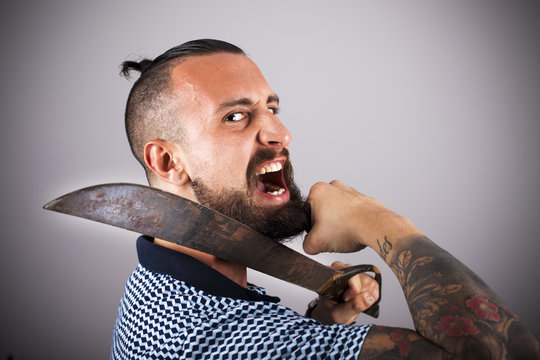 Hipster haciendo amago de cortarse la barba