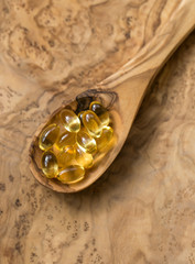 Fish oil capsules in a spoon