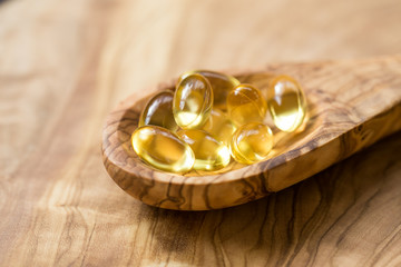 Fish oil capsules in a spoon