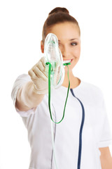 Female doctor holding up oxygen mask