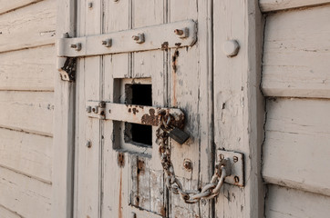 Old locked door with chain and padlocks