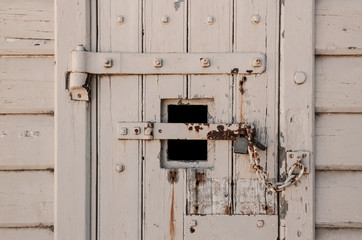 Fototapeta na wymiar Old locked door with chain and padlocks