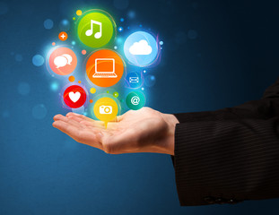 Naklejka premium Multimedia icons in the hand of a businessman